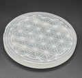 Selenite charging plate with Flower of Life engraving on white background – 10cm selenite plate for crystal cleansing and recharging