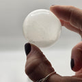 Selenite crystal ball 45 displayed on a wooden stand – polished sphere for altar or desk