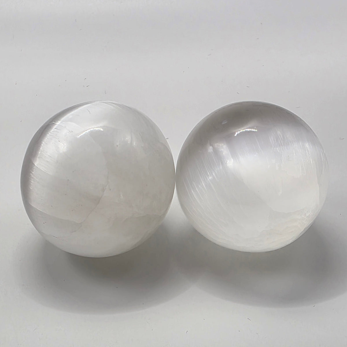 selenite crystal ball showing natural fibrous satin spar texture and chatoyant sheen
