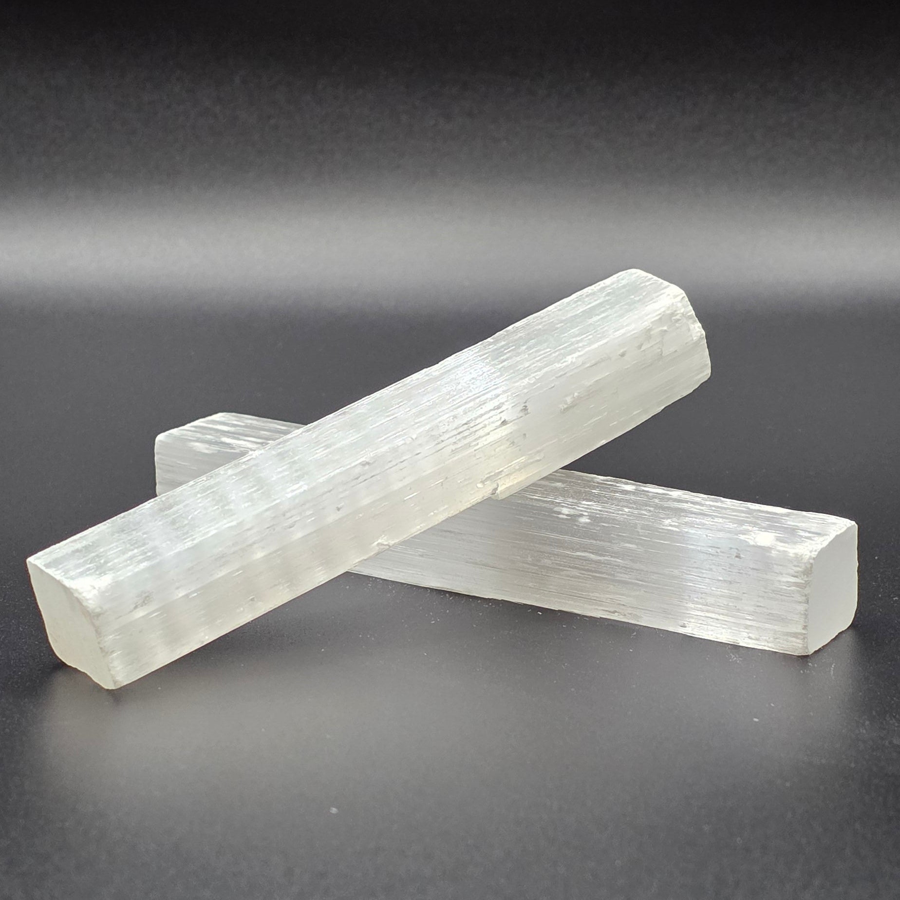 Natural selenite wands 10cm on black background – white healing crystal wand for cleansing and energy clearing