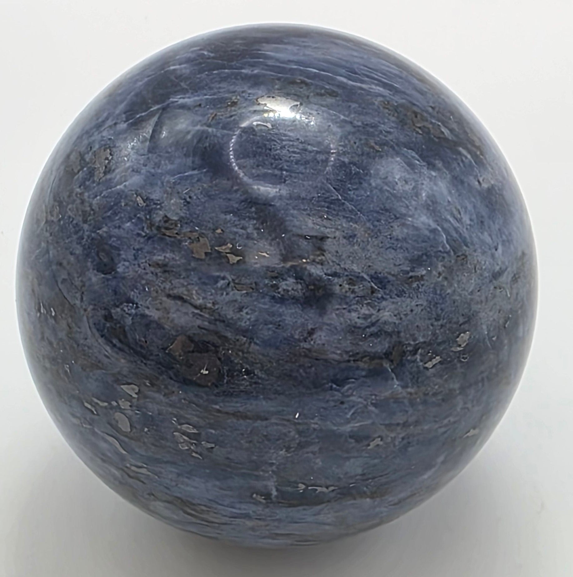 Sodalite sphere showing distinctive white veining and polished surface