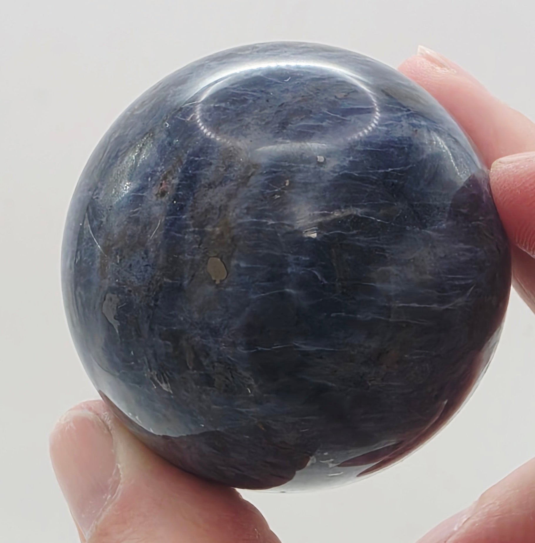 4cm sodalite sphere held in hand showing size