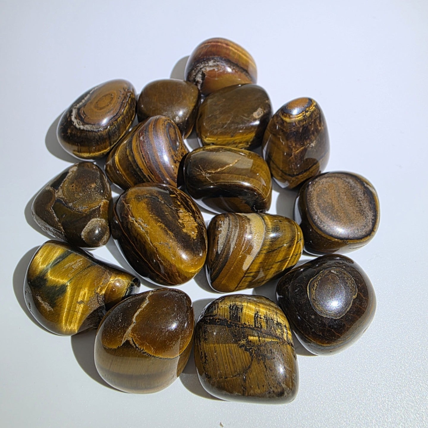 Collection of tiger eye stones on a white background