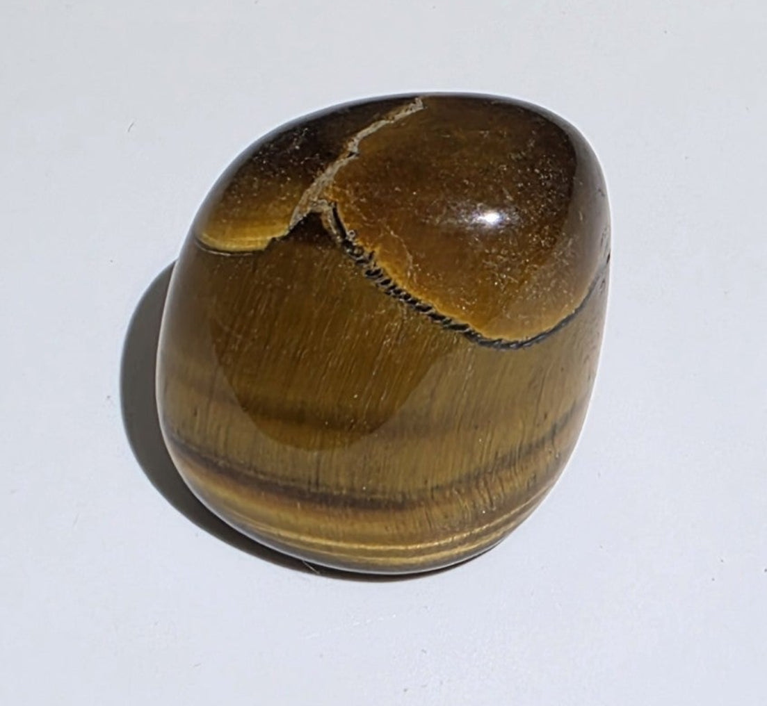 Brown tiger eye stone on a white background