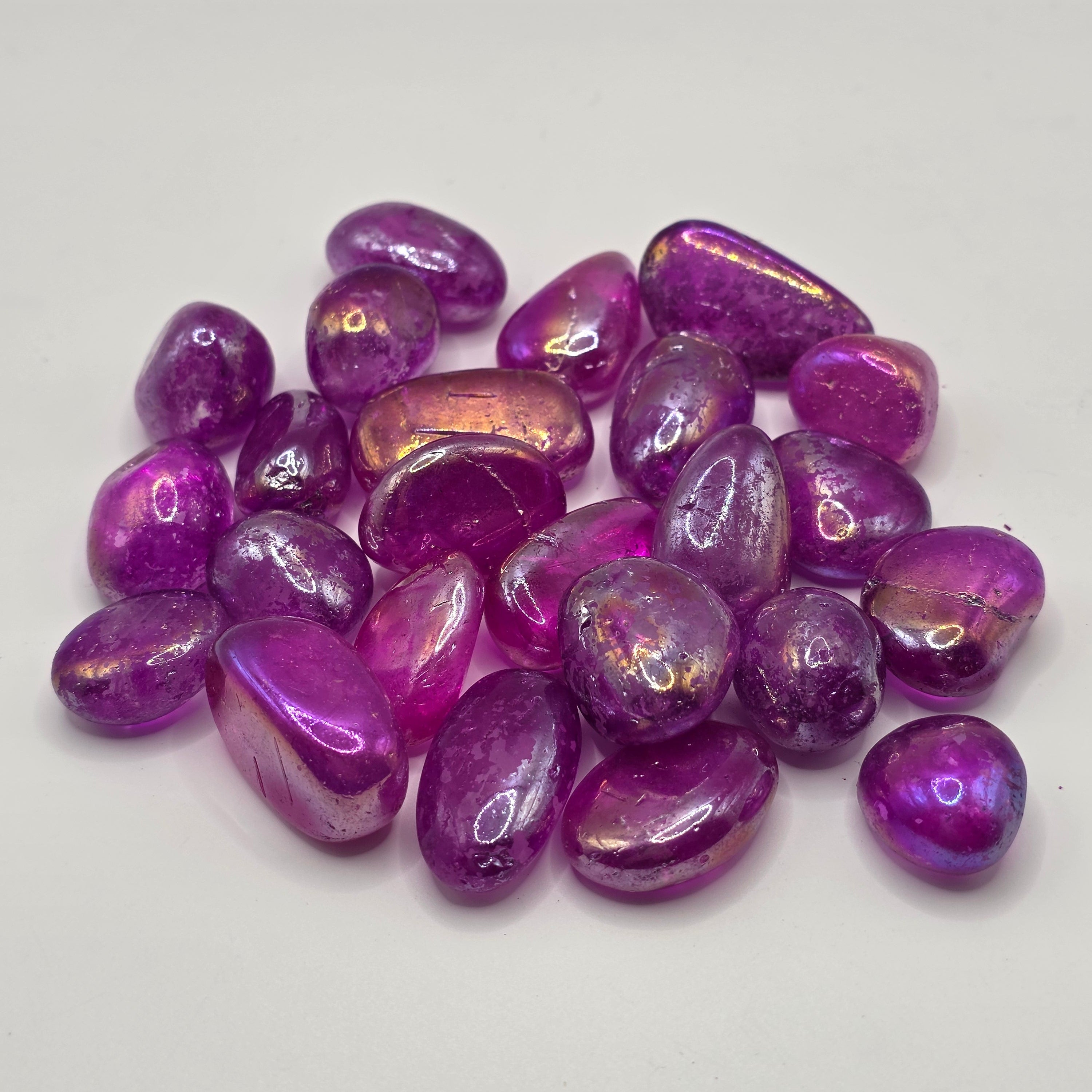 Group of witch aura tumbled stones showing variety of rainbow sheen colours